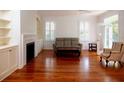 Bright living room featuring hardwood floors, built-in shelving, and natural light at 622 Venning St, McClellanville, SC 29458