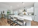 Bright, modern kitchen with white cabinets, quartz countertops, and stainless steel appliances at 7070 Pumpkinseed Dr, Johns Island, SC 29455