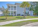 Charming two-story home with double porches, attached garage, and a well-manicured lawn at 7401 Purser Ln, Hanahan, SC 29410
