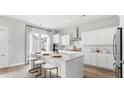 Modern kitchen boasts a large island with seating and sleek, white cabinetry at 778 Clay Field Trl, Summerville, SC 29485