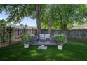 Serene backyard oasis featuring a seating area, lush lawn, and privacy fence at 1006 Ibis Ct, Mount Pleasant, SC 29464