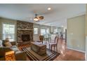 Cozy living room features a brick fireplace, hardwood floors, and an open layout at 1006 Ibis Ct, Mount Pleasant, SC 29464