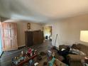 View of the living room area showcasing wood-look floors and a glimpse into the adjacent room at 1022 Miles Jamison Rd, Summerville, SC 29485