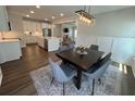 A cozy dining area featuring modern chandelier and opening to the large kitchen with stainless appliances at 104 Pine Waters Ln, Summerville, SC 29483