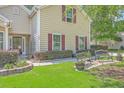 Inviting home featuring well-maintained lawn, garden bed, and seating creating a welcoming entrance at 105 Irish Oak Dr, Goose Creek, SC 29445