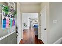 Warm and inviting foyer featuring hardwood floors, welcoming door decor, and a glimpse into the living spaces at 106 Wrigley Blvd, Summerville, SC 29485