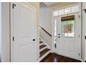 Warm and inviting foyer with hardwood floors, staircase, and natural light streaming through the front door at 106 Wrigley Blvd, Summerville, SC 29485