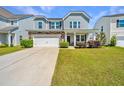 Beautiful two-story home features a two-car garage, manicured lawn, and attractive exterior details at 1110 Sapling Dr, Summerville, SC 29485