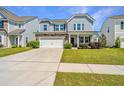 Inviting two-story home with a well-kept lawn, two-car garage, and a classic facade at 1110 Sapling Dr, Summerville, SC 29485