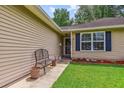 Inviting front porch with a cozy bench and well-manicured landscaping at 112 Red Cypress Dr, Goose Creek, SC 29445