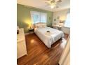 Cozy bedroom with a queen bed, hardwood floors, and stylish decor at 1159 Camden St, North Charleston, SC 29405