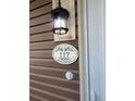 Close-up of the house number plaque displaying '117 Weiters St.' with ivy design and light fixture at 117 Weiters St, Walterboro, SC 29488