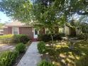 Beautiful single-story home featuring brown siding, lush landscaping, and a bird bath at 117 Weiters St, Walterboro, SC 29488