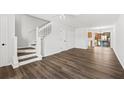 Open-concept living area with wood-look floors and a staircase at 122 Hornby Cir, Goose Creek, SC 29445