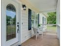 Charming front porch featuring a decorative glass door and cozy seating area at 123 Fall Creek Blvd, Summerville, SC 29483