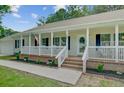 Inviting front porch with white railings, brick accents, and a well-maintained garden at 123 Fall Creek Blvd, Summerville, SC 29483