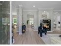 Open-concept living room with elegant fireplace, modern decor, and abundant natural light at 123 Fall Creek Blvd, Summerville, SC 29483