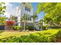 Beautiful backyard with lush landscaping, a well-manicured lawn, and a charming exterior elevation at 1331 Smythe St, Daniel Island, SC 29492