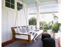 Relaxing porch featuring a comfortable swing, stylish pillows, and serene outdoor ambiance at 1331 Smythe St, Daniel Island, SC 29492