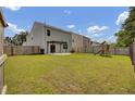 A spacious backyard featuring a green lawn, privacy fence, patio, and playground perfect for entertaining at 138 Sweet Cherry Ln, Summerville, SC 29486