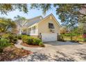 Exterior view of the garage and side of the house with a basketball hoop on the garage at 1511 Fairway Dr, Charleston, SC 29412