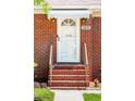 Close-up of the brick home's front door, featuring a white awning and decorative details at 1915 Aichele Dr, North Charleston, SC 29406