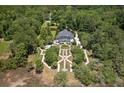 Expansive property showcasing a grand home, manicured gardens, pool, and private wooded acreage at 1972 Long Creek Rd, Wadmalaw Island, SC 29487