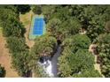 Private tennis court nestled within lush greenery and alongside a serene creek at 1972 Long Creek Rd, Wadmalaw Island, SC 29487
