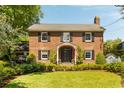 Beautiful two-story brick home with manicured lawn, featuring black shutters and an American flag at 2 Pierates Cruz, Mount Pleasant, SC 29464