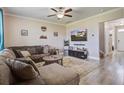 Living room featuring an entertainment center, plush sofa, area rug, and abundant natural light at 2113 Pimlico Dr, Ridgeville, SC 29472
