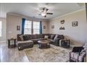 Inviting living room features plush sectional sofa, area rug, and natural light, perfect for relaxing or entertaining at 2113 Pimlico Dr, Ridgeville, SC 29472