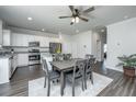 Bright kitchen with white cabinets, stainless steel appliances, granite countertops, and an adjacent dining area at 222 Torslanda Ln, Summerville, SC 29486
