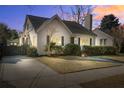 Inviting home with a brick facade, trimmed hedges, and a driveway leading to a detached garage at 229 Gordon St, Charleston, SC 29403