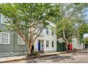 Charming two-story home with a blue front door and well-maintained landscaping in a desirable neighborhood at 23 Felix St, Charleston, SC 29403