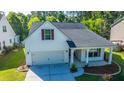 Charming home featuring an attached garage, inviting front porch, and tidy landscaping at 2314 Hummingbird Ln, Summerville, SC 29483