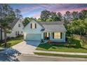 Charming home featuring a well-manicured lawn, attached garage, and inviting front porch at 2314 Hummingbird Ln, Summerville, SC 29483