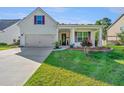 Charming home with manicured lawn, tidy flower beds, attached garage and inviting front porch at 2314 Hummingbird Ln, Summerville, SC 29483
