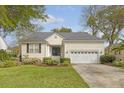 Beautiful single-story home with a manicured lawn, mature landscaping, and an attached two-car garage at 2525 Bent Tree Ln, Mount Pleasant, SC 29464