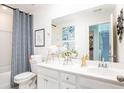 Bright bathroom featuring a patterned shower curtain, decorative mirror and dual vanity at 259 Camellia Bloom Dr, Moncks Corner, SC 29461