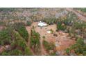 Aerial view of a home surrounded by colorful fall trees and a dirt road leading up to the property at 280 Royalegates Ct, Cross, SC 29436
