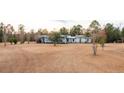 Spacious single-story home with large front lawn and mature trees surrounding the property at 280 Royalegates Ct, Cross, SC 29436