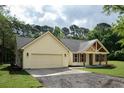 A beautiful exterior shot of a single-Gathering home featuring a large, attached two-car garage at 2836 Edenborough Rd, Johns Island, SC 29455