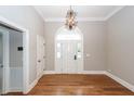 Bright foyer showcasing hardwood floors and an elegant chandelier at 287 Commonwealth Rd, Mount Pleasant, SC 29466