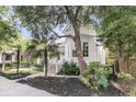 Beautiful exterior view of this white home surrounded by lush landscaping and a brick perimeter wall at 300 Ginned Cotton St, Charleston, SC 29492