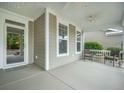 Inviting front porch with a ceiling fan and comfortable seating, perfect for relaxing outdoors at 3006 Cross Vine Ln, Summerville, SC 29483