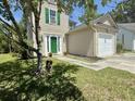 Charming two-story home featuring green shutters, a bright green door, a lush lawn, and a one-car garage at 319 Parish Park, Summerville, SC 29485