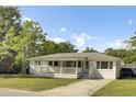 Cozy one-story home with a charming front porch and a well-kept yard at 32 Elmora Ave, Goose Creek, SC 29445