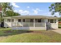 Inviting home featuring a lovely front porch and freshly manicured lawn at 32 Elmora Ave, Goose Creek, SC 29445