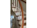 Beautiful staircase with curved wood railing and white spindles at 330 Concord St # Th17, Charleston, SC 29401