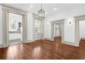 Elegant living room with hardwood floors, white trim, and doorways leading to other rooms at 35 Society St # D, Charleston, SC 29401